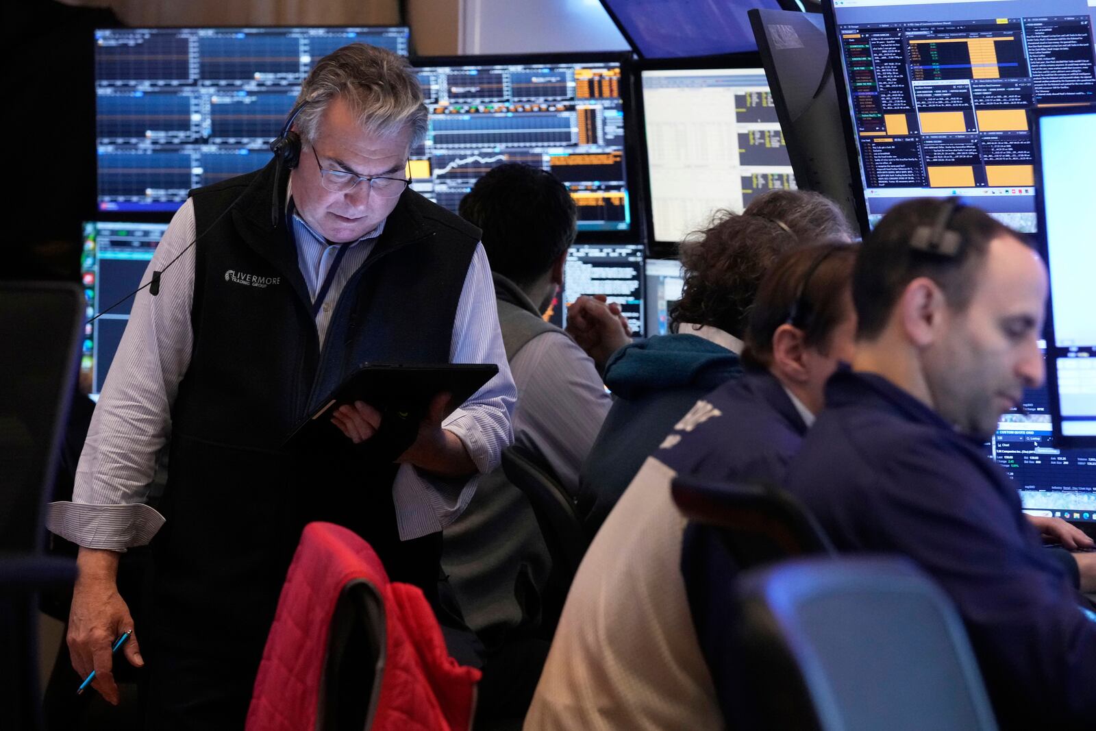 Traders work on the floor of the New York Stock Exchange, Tuesday, April 15, 2025. (AP Photo/Richard Drew)