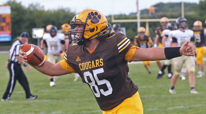 Kenton Ridge's Jayden Rowland yells as he crosses the goal line to score a touchdown against Ben Logan. BILL LACKEY/STAFF