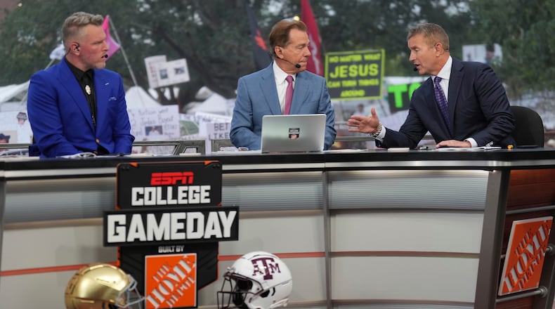 FILE - From left, Pat Mcafee, Nick Saban and Kirk Herbstreit talk on the set of ESPN College Gameday on Saturday, Aug. 31, 2024, in College Station, Texas. (AP Photo/Sam Craft, File)
