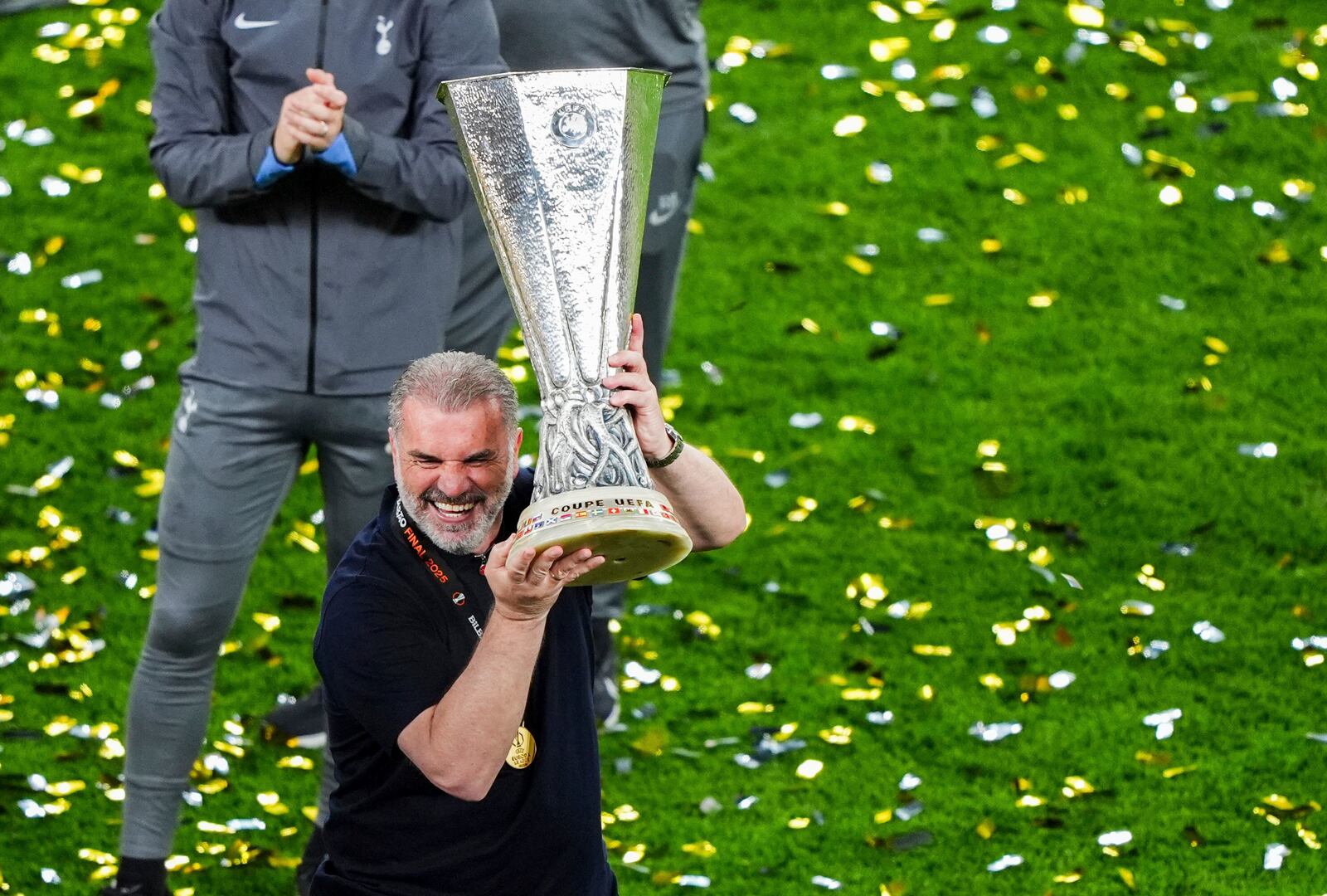 Tottenham Hotspur manager Ange Postecoglou lifts the Europa League trophy following the team's victory over Manchester United at the Estadio de San Mames, Bilbao, Spain, Wednesday, May 21, 2025. (Andrew Milligan/PA via AP)