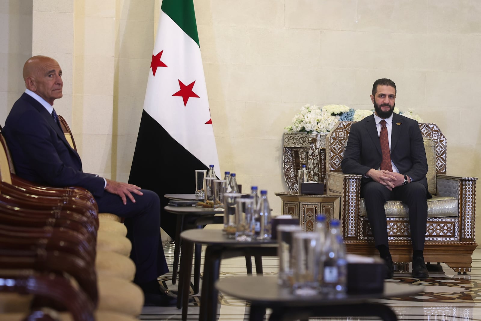 Syria's interim president, Ahmad al-Sharaa, right, meets with U.S. Ambassador to Turkey and Special Envoy to Syria Tom Barrack at the People's Palace in Damascus, Syria, Wednesday, July 9, 2025. (AP Photo/Ghaith Alsayed)