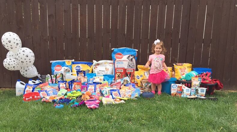 Eloise McKinnon stands next to some of the donations for local animal shelters that were raised at her birthday party. Contributed photo