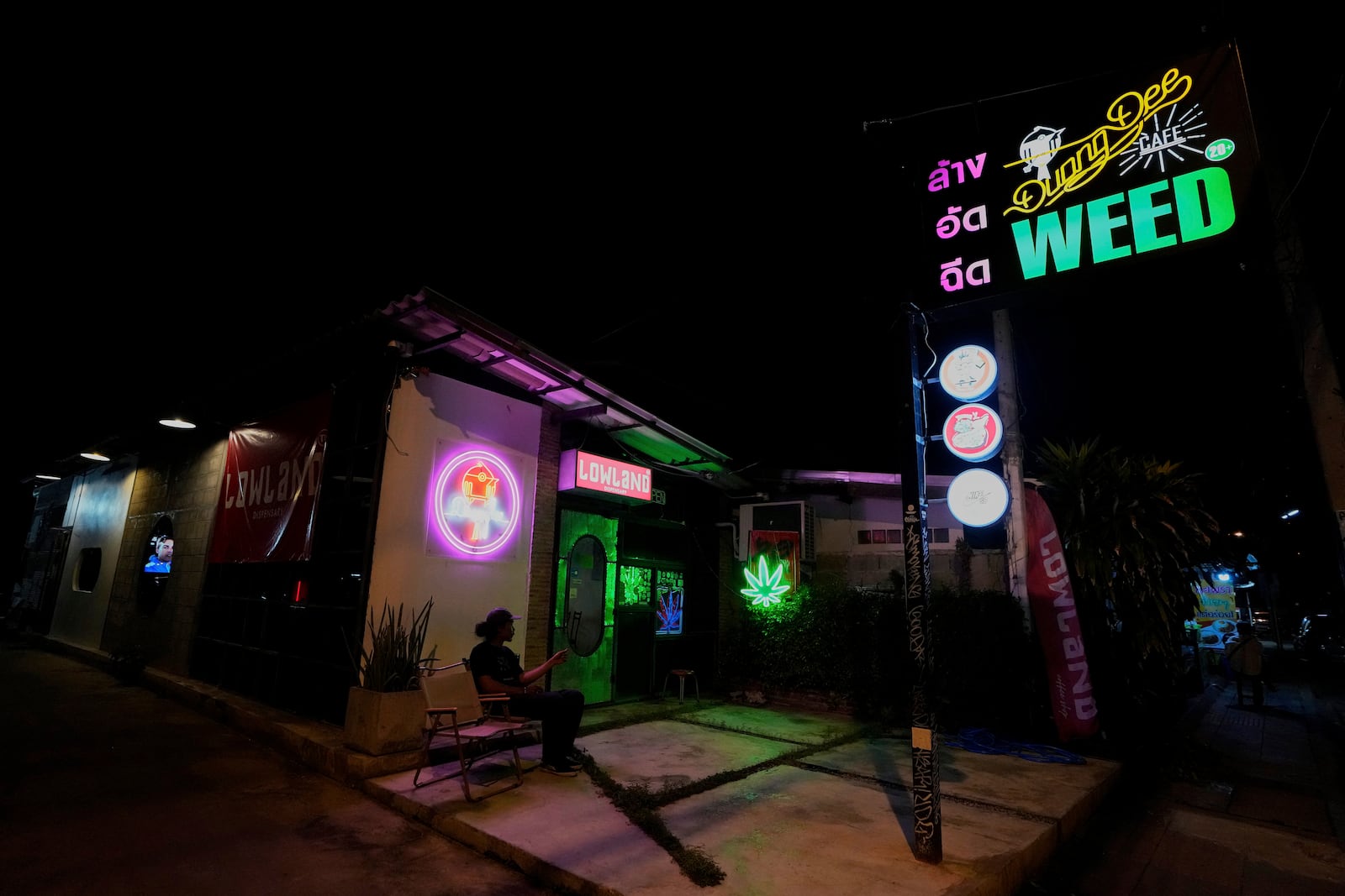 FILE--A customer sits outside a cannabis shop in Kanchanaburi province, west of Bangkok, Thailand, July 16, 2024. (AP Photo/Sakchai Lalit, File)