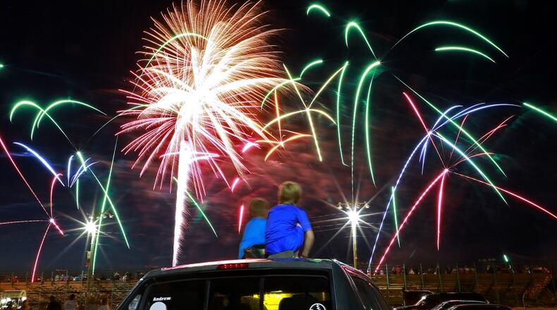 Two boys watch Clark County Fireworks display on Monday, July 1, 2019 at the Clark County Fairgrounds. BILL LACKEY/STAFF