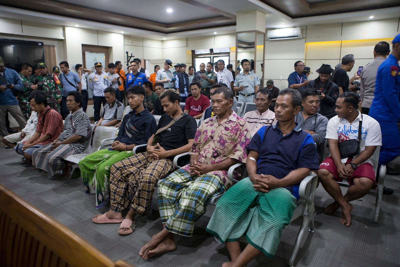 Survivors rescued after a ferry sank wait for a health examination in Gilimanuk on Bali island, Indonesia, Thursday, July 3, 2025. (AP Photo/Firdia Lisnawati)