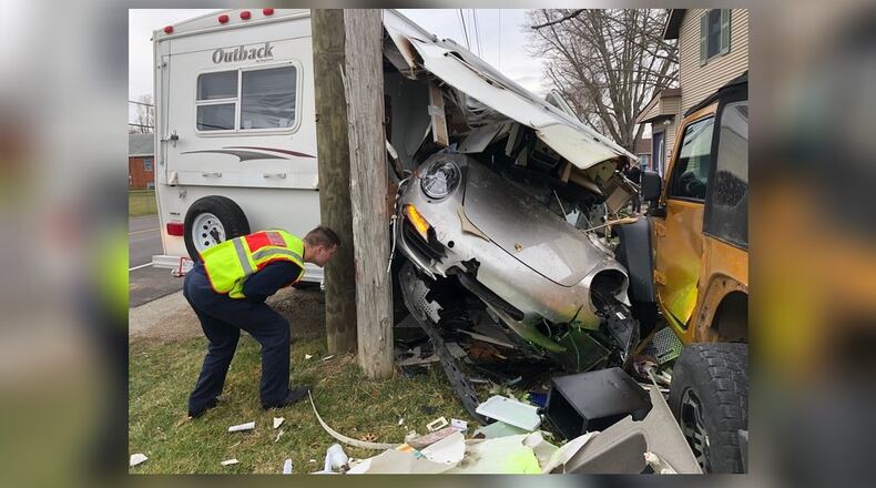 The driver of a silver Porsche 911 lost control on Springfield Xenia Road and crashed into two parked cars before smashing through a camper also parked along the road March 16, 2020, in Springfield Twp., Clark County. BILL LACKEY/STAFF