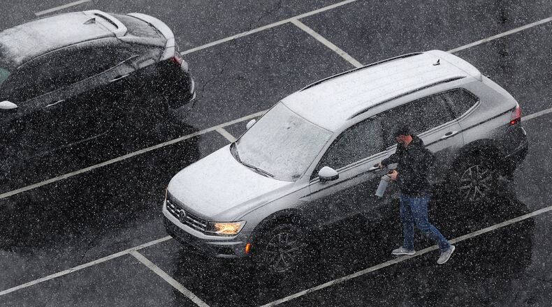Workers have to remove snow from their cars Friday, Feb. 16, 2024 before going home. MARSHALL GORBY\STAFF
