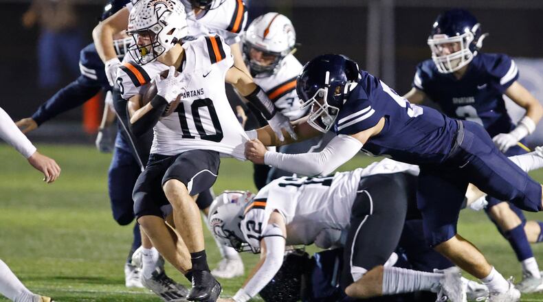 Valley View's Bryce Reed tries to bring down Waynesville's Garrett Lundy during their playoff game at Spingboro Friday, Nov. 17, 2023. BILL LACKEY/STAFF