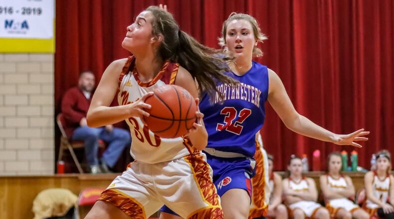 Northeastern High School freshman Isabella Allison drives to the hoop against Northwestern’s Mattie Steiner during their game against Northwestern on Monday, Dec. 30. CONTRIBUTED PHOTO BY MICHAEL COOPER