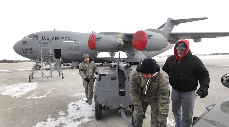 Airmen repair a fuel boost pump on a 445th Airlift Wing C-17 cargo jet at Wright-Patterson Air Force Base in this 2013 file photo. The Air Force has said it has reduced a shortage of aircraft maintainers. LISA POWELL/STAFF