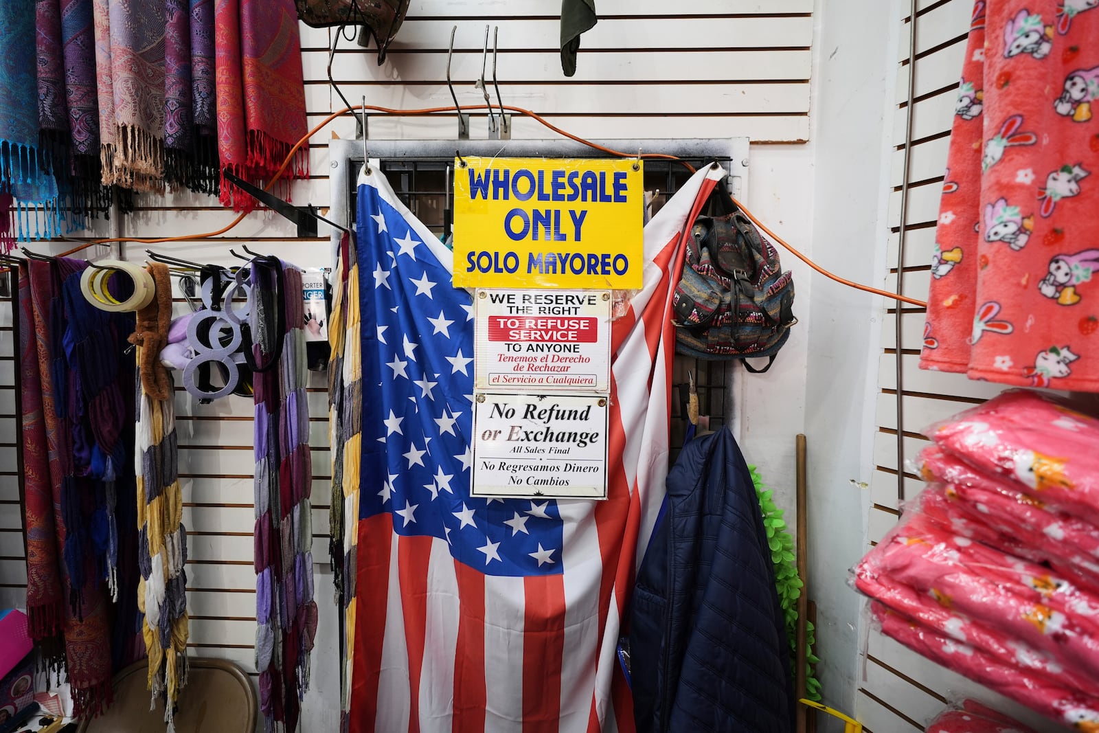 FILE - An American flag hangs in a store owned by Kyung Sook Im in the Toy District of Los Angeles, Wednesday, April 9, 2025, where the majority of the merchandise is imported from China. (AP Photo/Jae C. Hong, File)