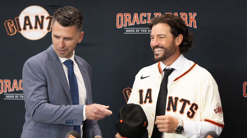San Francisco Giants President of Baseball Operations Buster Posey, left, welcomes Tony Vitello as the new manager of the San Francisco Giants baseball team on Thursday, Oct. 30, 2025, in San Francisco. (AP Photo/Benjamin Fanjoy)