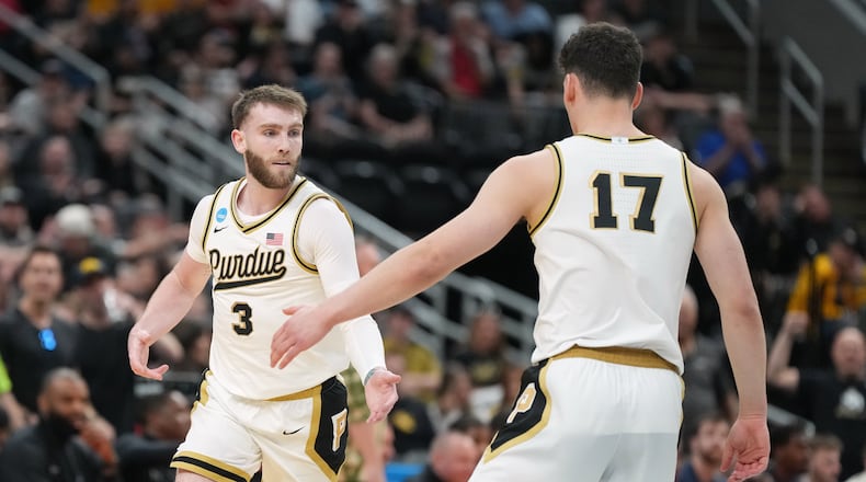 Purdue's Braden Smith (3) is congratulated by teammate Omer Mayer (17) after making a 3-point basket during the first half in the first round of the NCAA college basketball tournament against Queens University, Friday, March 20, 2026, in St. Louis. (AP Photo/Jeff Roberson)