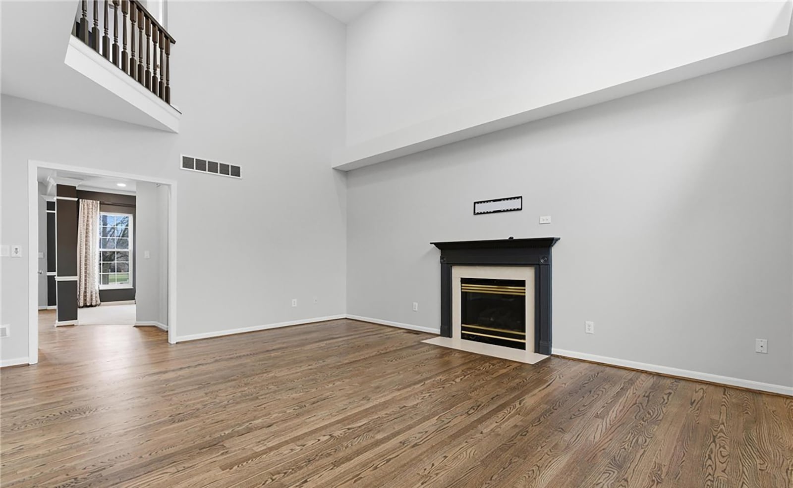 The two story great room has refinished hardwood floors and a gas fireplace. It is open to the kitchen. CONTRIBUTED