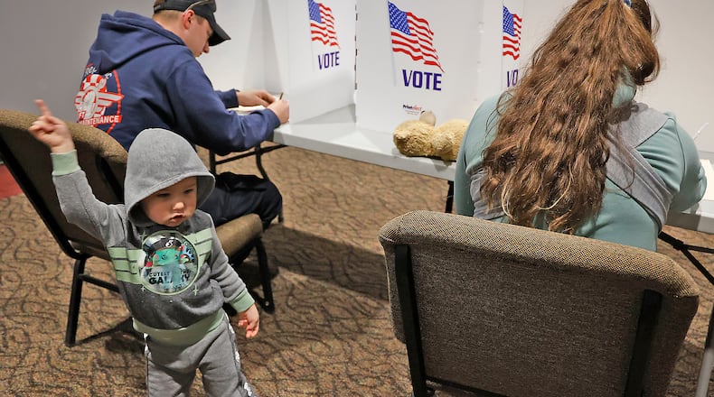 Two-year-old Mathew McLain dances around as his parents cast their vote Tuesday, Nov. 8, 2022, at the First Christian Church in Moorefield Township in Clark County. BILL LACKEY/STAFF