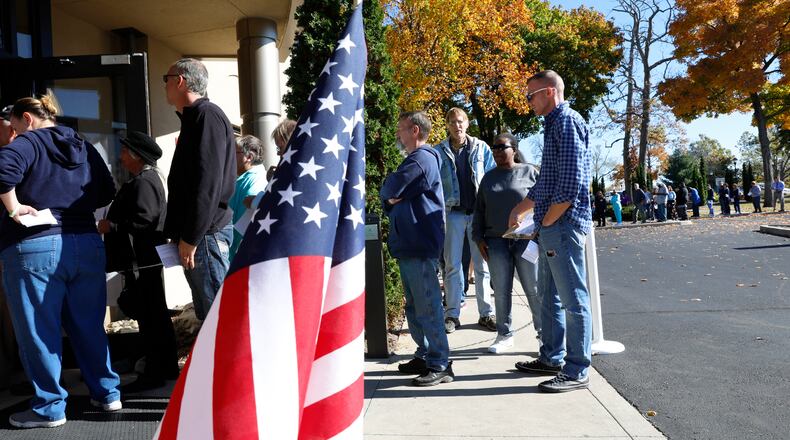 A line of voters stretches out the door and around the parking lot of the Clark County Board of Elections as people wait for over an hour to cast their vote during early voting last year. BILL LACKEY/STAFF