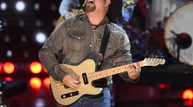 FILE - This March 14, 2019 file photo shows Garth Brooks performing at the iHeartRadio Music Awards in Los Angeles. Brooks is holding a concert in Nashville,Tenn., that will be played at 300 drive-in theaters across the country. Tickets will cost $100 per passenger car or truck.