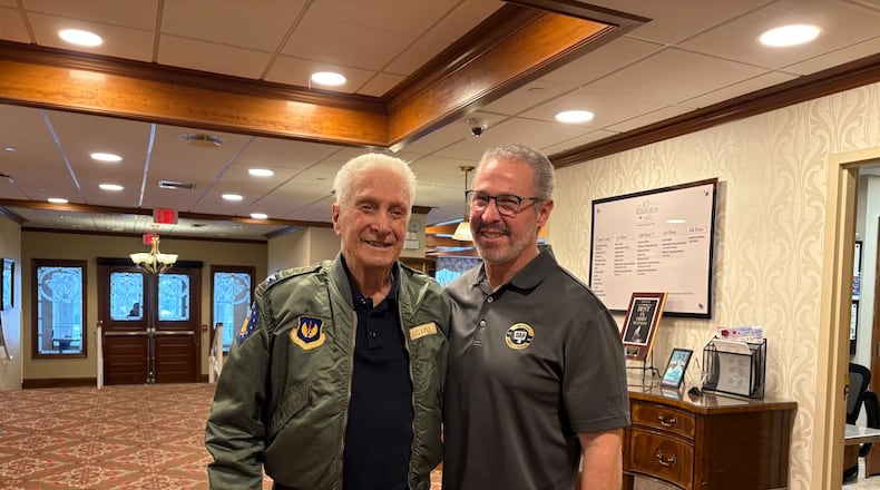Father and son, both named Joseph Adamo. The older Mr. Adamo, left, celebrates his 100th birthday Feb. 11. His son is 65. The elder Adamo lives at the 10 Wilmington Place retirement community in Dayton, where this photo was taken Feb. 2, 2026. THOMAS GNAU/STAFF