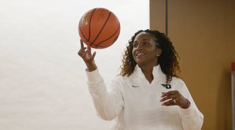 Tamika Williams-Jeter poses for a photo after being introduced as the new head women's basketball coach at Dayton on Monday, March 28, 2022, at UD Arena. David Jablonski/Staff