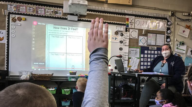 First-graders at Orchard Park Elementary School in Kettering work on an activity Tuesday March 2, 2021. The school is open for in-person learning after nearly a year of COVID-19 restrictions.