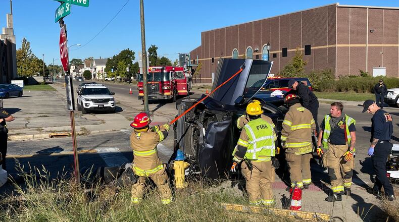 The Springfield Fire Division rescued the driver of an overturned SUV after it was involved in a two-vehicle crash at the intersection of West High Street and South Lowry Avenue Monday, Oct. 3, 2022. The driver was transported to Springfield Regional Medical Center with non-life-threatening injuries. BILL LACKEY/STAFF