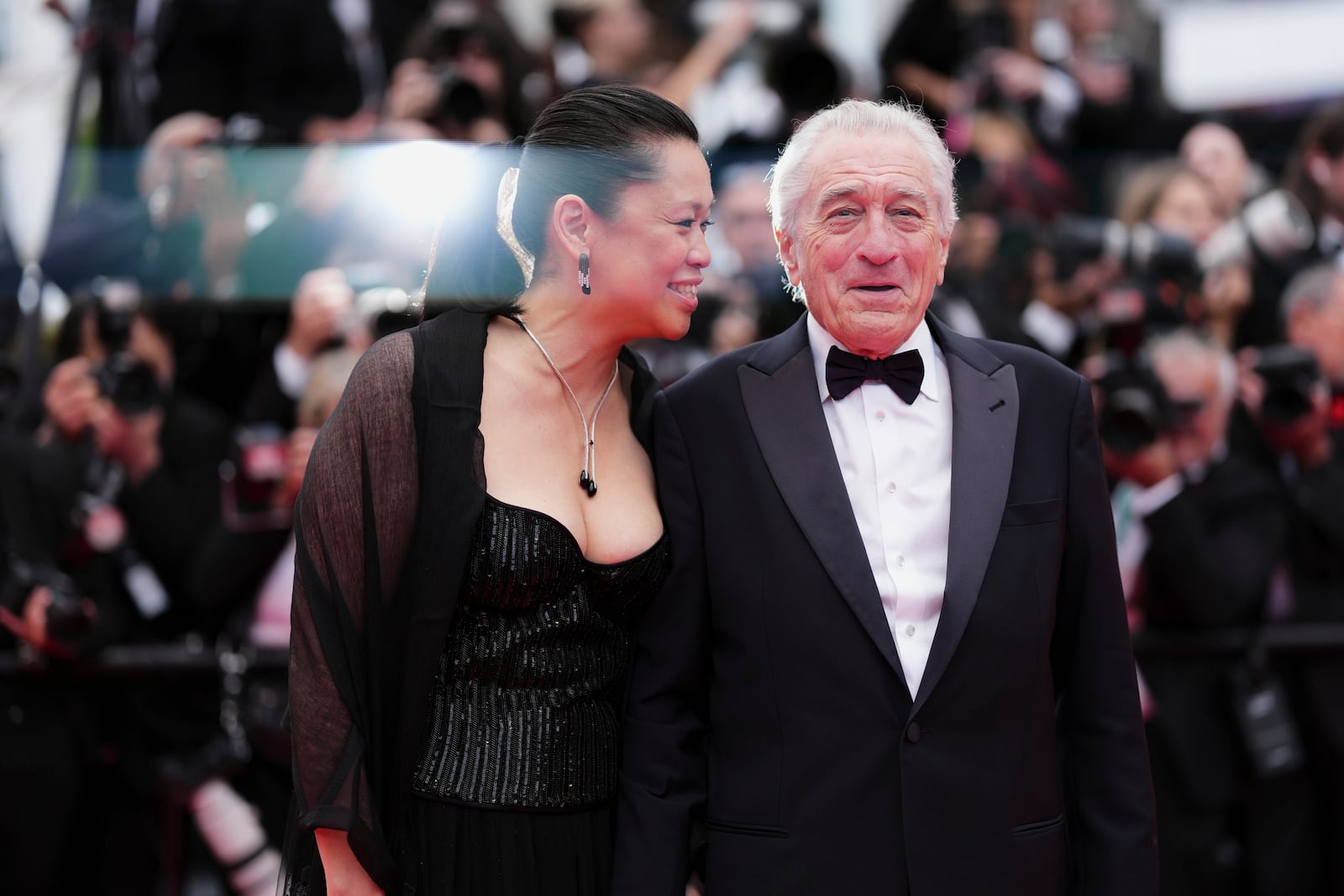 Tiffany Chen, left, and Robert De Niro pose for photographers during the opening ceremony red carpet of the 78th international film festival, Cannes, southern France, Tuesday, May 13, 2025. (Photo by Scott A Garfitt/Invision/AP)
