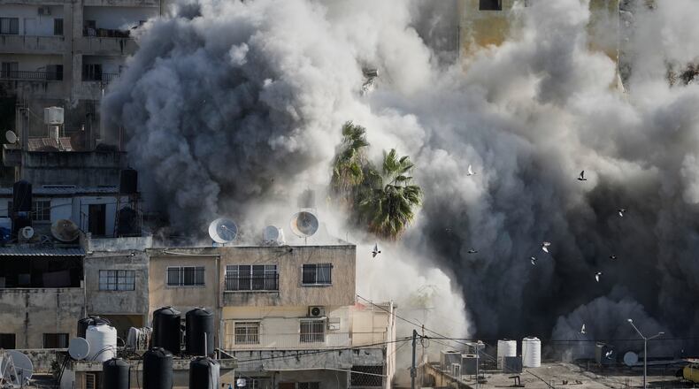 Smoke rises as Israeli forces demolish the home of Abdul Karim Sanoubar, a suspected Palestinian militant who has been accused by Israel of planting bombs on buses in central Israel, in Nablus, West Bank, Tuesday, Dec. 2, 2025. (AP Photo/Majdi Mohammed)