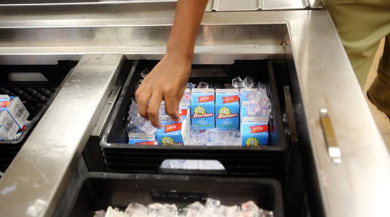 A student selects a carton of milk in the cafeteria at John F. Kennedy Middle. (Bruce R. Bennett/The Palm Beach Post)