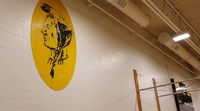 The Native American sign that once was on the outside of Shawnee High/Middle School has been relocated to the North Gymnasium to preserve it. The paint on the sign is cracked and in danger of falling off the metal sign. BILL LACKEY/STAFF