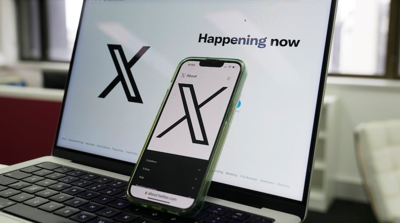 FILE - The opening page of X is displayed on a computer and phone, Oct. 16, 2023, in Sydney. (AP Photo/Rick Rycroft, File)