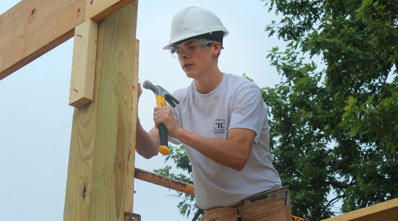 Springfield-Clark Career Technology Center student Seth Lanigan helps build a new Dog Barn at the Clark County Fairgrounds. JEFF GUERINI/STAFF