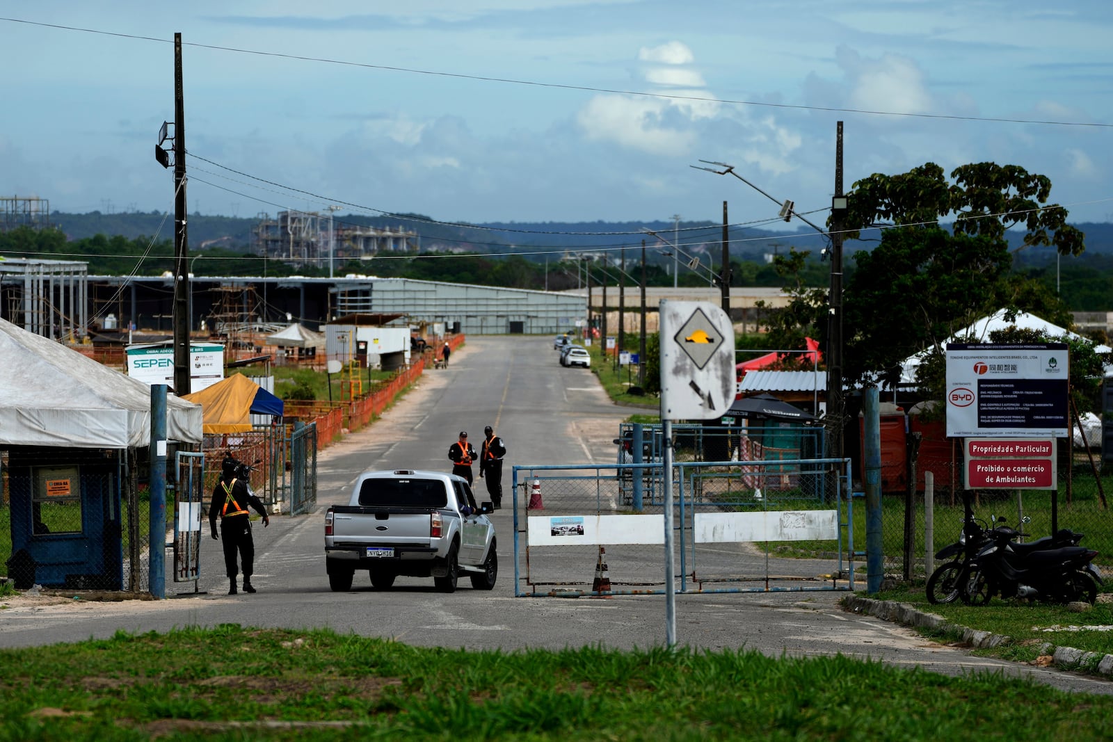 Security guards control access to the BYD vehicle factory being built in Camacari, Bahia state, Brazil, Thursday, March 6, 2025. (AP Photo/Eraldo Peres)