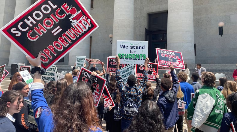 Students and parents rally at the Ohio Statehouse in support of possible changes that would increase eligibility for taxpayer-funded school vouchers to K-12 students statewide on Thursday, May 17, 2023, in Columbus, Ohio. Advocates applaud the changes as expanding school choice but opponents say such programs divert funding from public schools and violate Ohio's constitution. (AP Photo/Samantha Hendrickson)