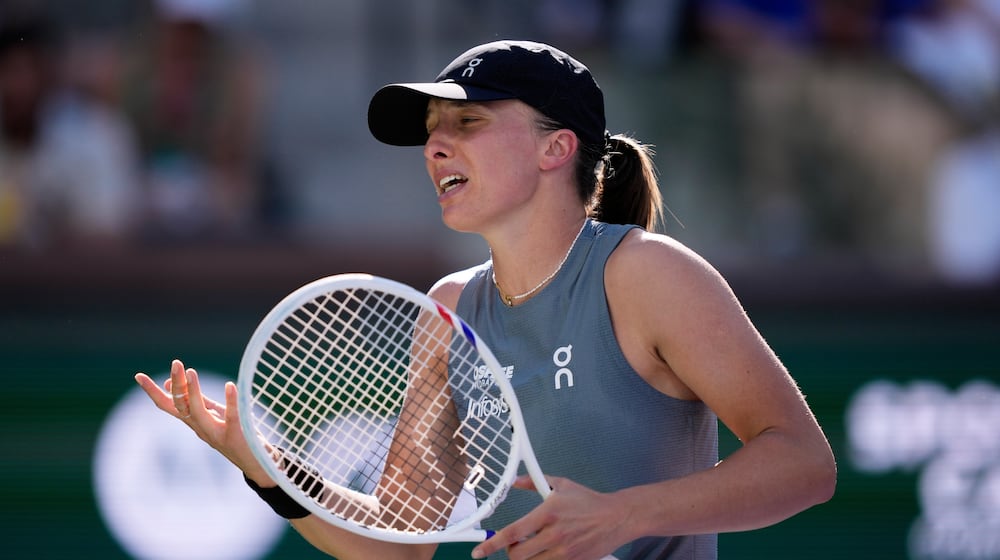 Iga Swiatek, of Poland, reacts after losing a point against Elina Svitolina, of Ukraine, during a quarterfinal match at the BNP Paribas Open tennis tournament, Thursday, March 12, 2026, in Indian Wells, Calif. (AP Photo/Mark J. Terrill)