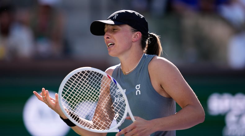 Iga Swiatek, of Poland, reacts after losing a point against Elina Svitolina, of Ukraine, during a quarterfinal match at the BNP Paribas Open tennis tournament, Thursday, March 12, 2026, in Indian Wells, Calif. (AP Photo/Mark J. Terrill)