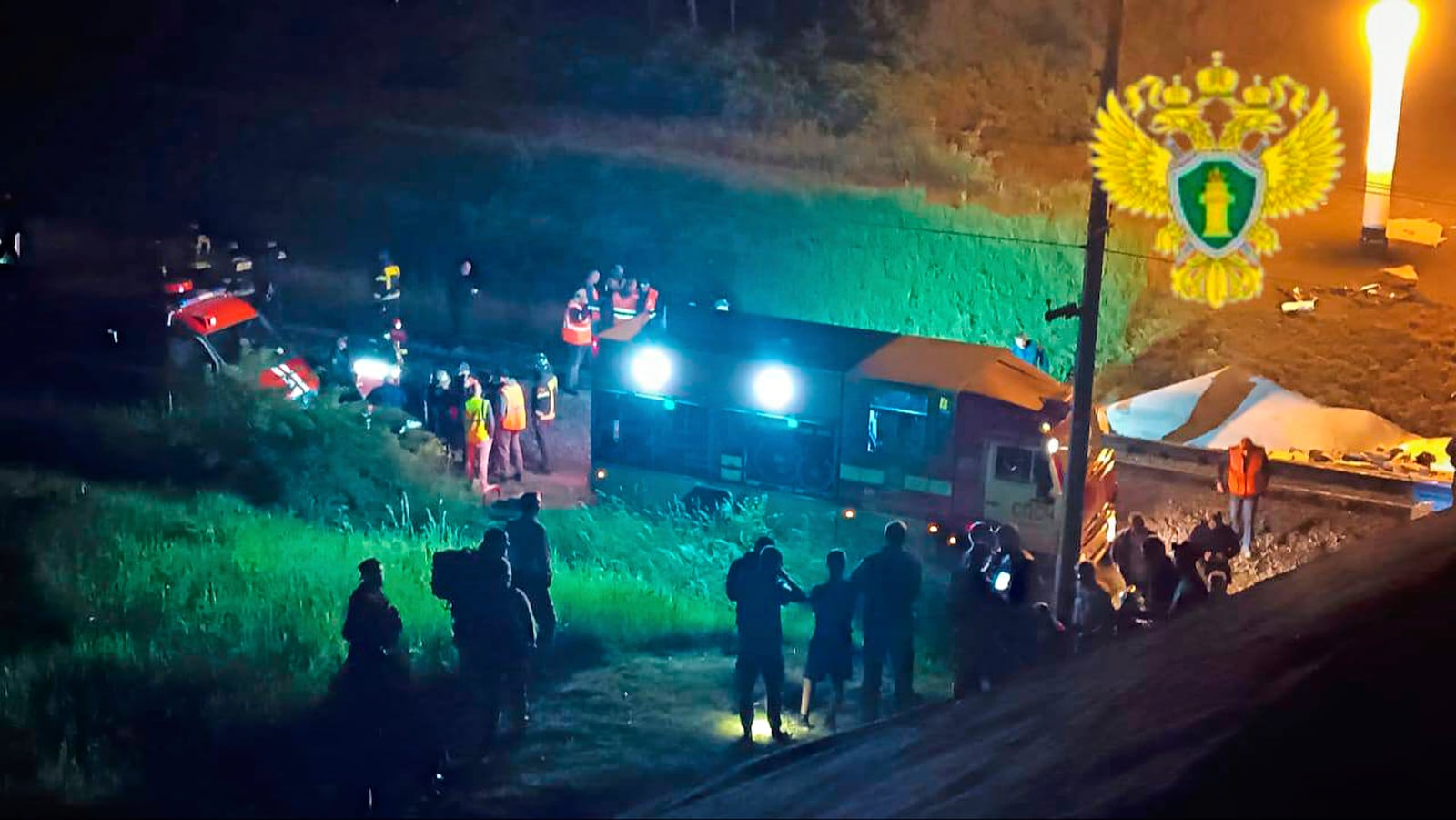In this photo released by Moscow Interregional Transport Prosecutor's Office telegram channel on Sunday, June 1, 2025, emergency employees work at a damaged bridge in Russia's Bryansk region, which borders Ukraine. (Moscow Interregional Transport Prosecutor's Office telegram channel via AP)