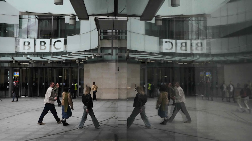 FILE - Pedestrians are reflected as they walk outside BBC Broadcasting House in London, Tuesday, Nov. 11, 2025. (AP Photo/Kirsty Wigglesworth, file)