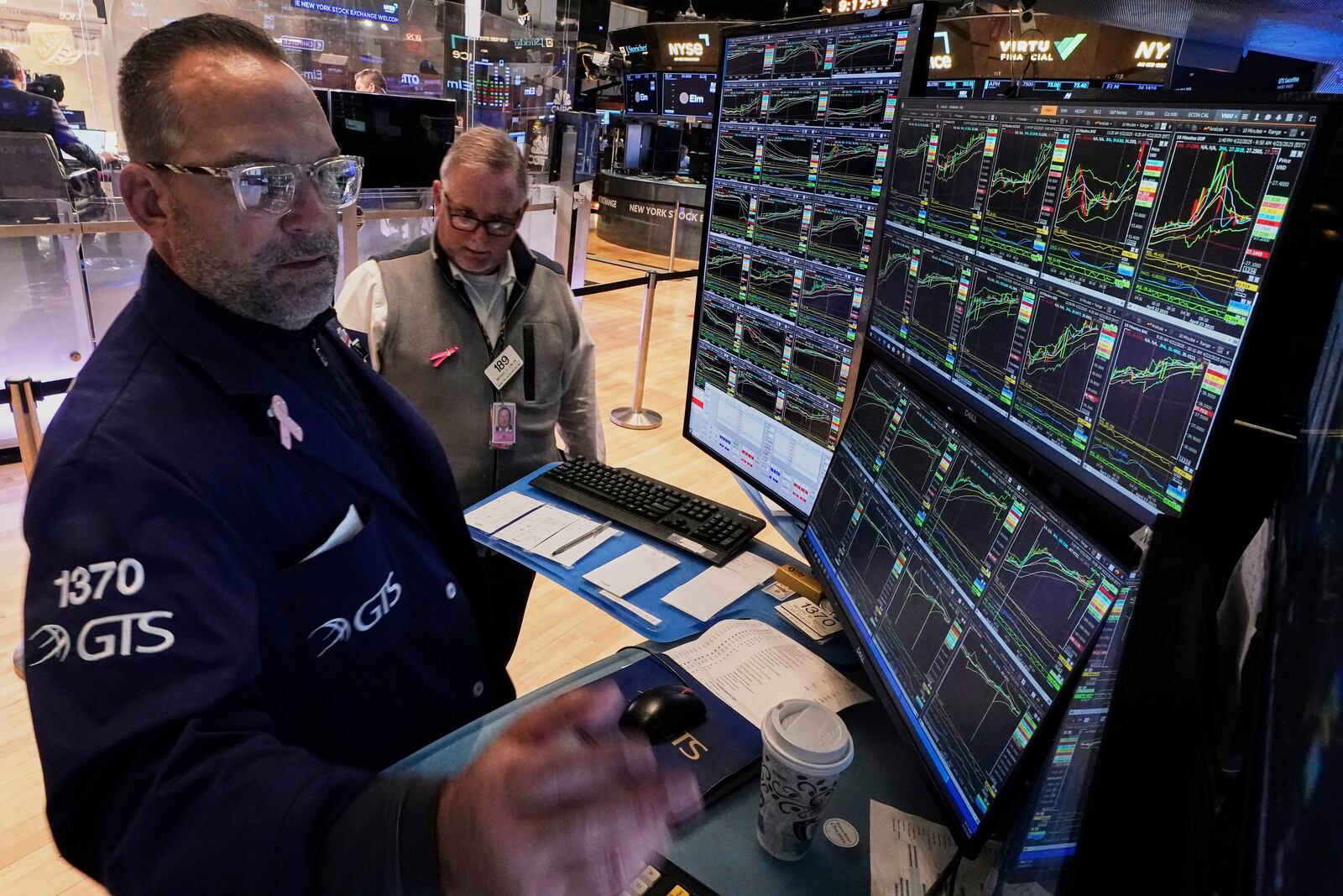 Specialist Anthony Matesic, left, and trader Michael Conlon work on the floor of the New York Stock Exchange, Wednesday, April 23, 2025. (AP Photo/Richard Drew)