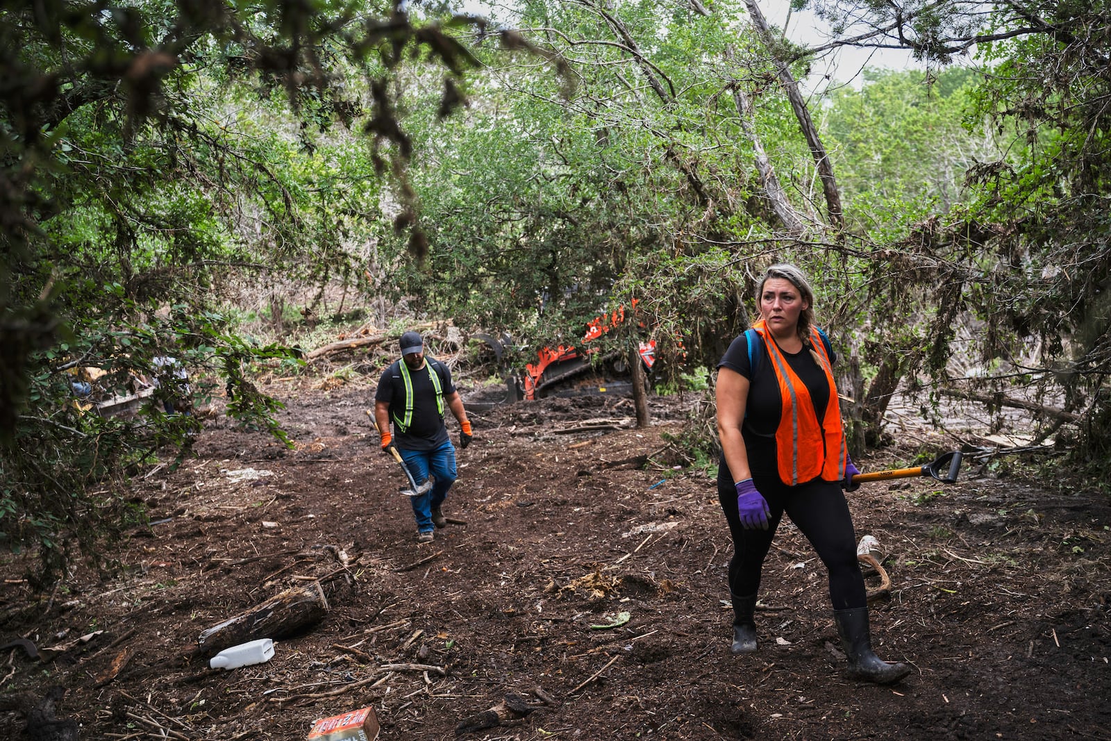 Volunteers carry out search and rescue operations near the Guadalupe River after a flash flood swept through the area Monday, July 7, 2025, in Ingram, Texas. (AP Photo/Eli Hartman)