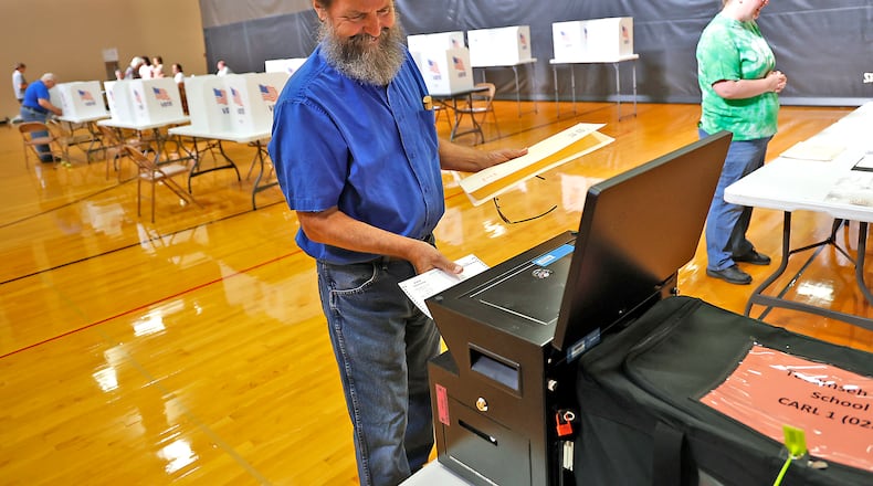 Roger Phipps votes at Tecumseh High School Tuesday, August 8, 2023. BILL LACKEY/STAFF