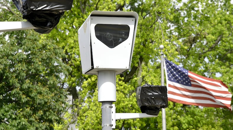 Bags cover red light cameras in Springfield after the city shut them off following a new state law requiring an officer to be present for a ticket to be issued. Bill Lackey/Staff