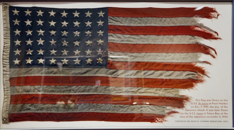 This flag flew on the USS St. Lous in Hawaii during the attack on Pearl Harbor on Dec. 7, 1941. The same flag then flew on the USS Iowa in Tokyo Bay during the Japanese Surrender in 1945. The flag was donated to the National Museum of the U.S. Air Force by Middletown resident Ralph W. Youmans. TY GREENLEES / STAFF