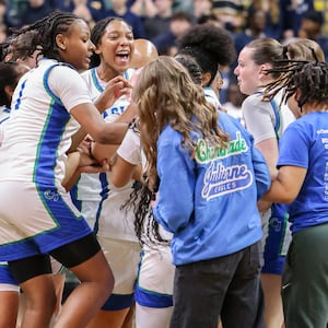 Chaminade-Julienne players celebrate after defeating Copley 62-57 in a Division III state semifinal on Thursday, March 12 at Ervin J. Nutter Center in Fairborn. BRYANT BILLING / STAFF