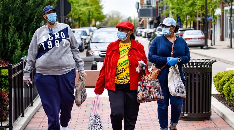 Joey Shields, left, Josephine Gates, middle, and Shelley Gates wear masks as they shop at Liberty Center in Liberty Township on the first day most retail stores were allowed to open Tuesday, May 12, 2020. Most non-essential retail stores have been closed to the public since the stay-at-home order went into place due to the coronavirus pandemic. NICK GRAHAM / STAFF