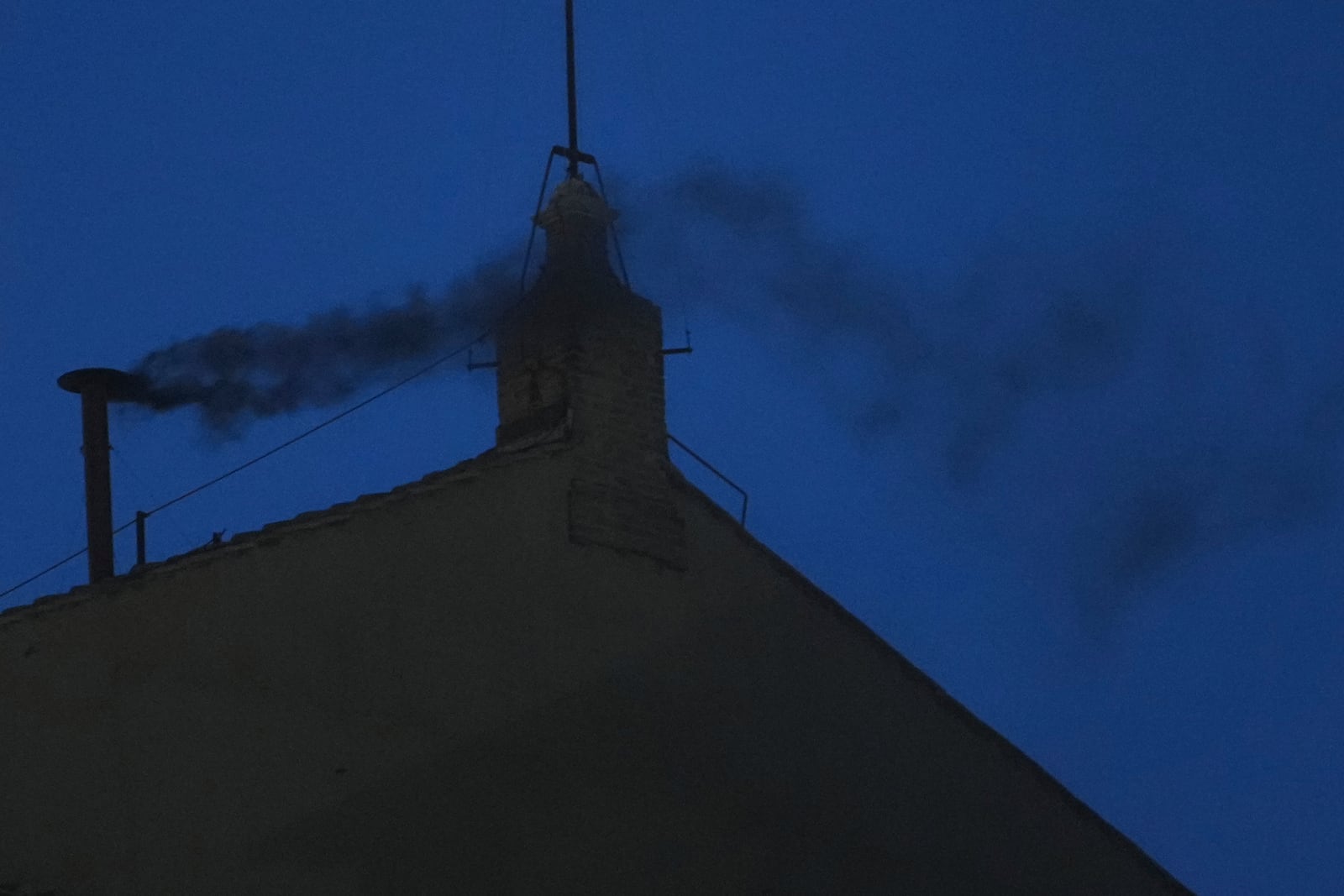 Black smoke billows from the chimney of the Sistine Chapel during the cardinals' conclave to elect a new pope, at the Vatican, Wednesday, May 7, 2025. (AP Photo/Alessandra Tarantino)