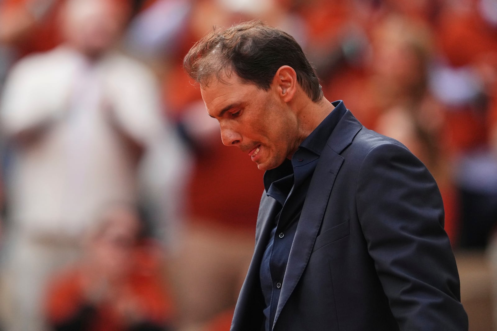 Rafa Nadal is overwhelmed with emotion during a farewell ceremony at center court Philippe-Chatrier, at the Roland-Garros stadium, in Paris, Sunday May 25, 2025 (AP Photo/Lindsey Wasson)