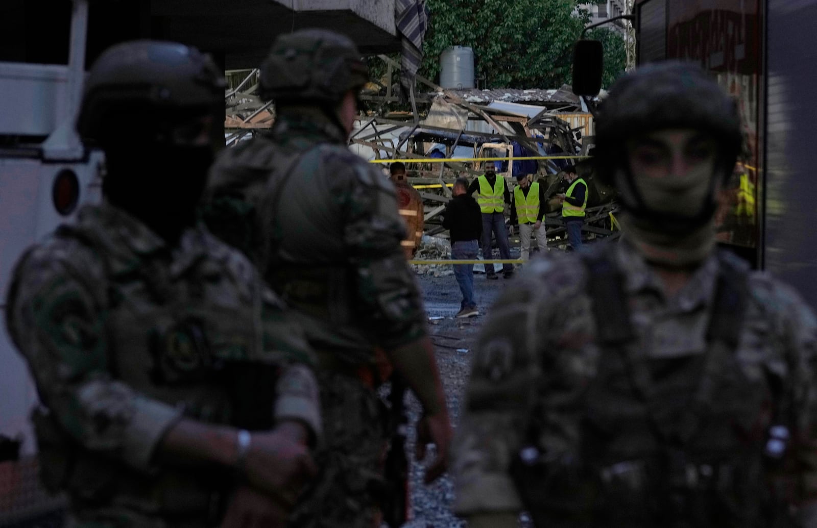 Civil defence workers and Lebanese soldiers gather at the site of an Israeli airstrike in Dahiyeh in the southern suburb of Beirut, Lebanon, Sunday, April 27, 2025. (AP Photo/Bilal Hussein)
