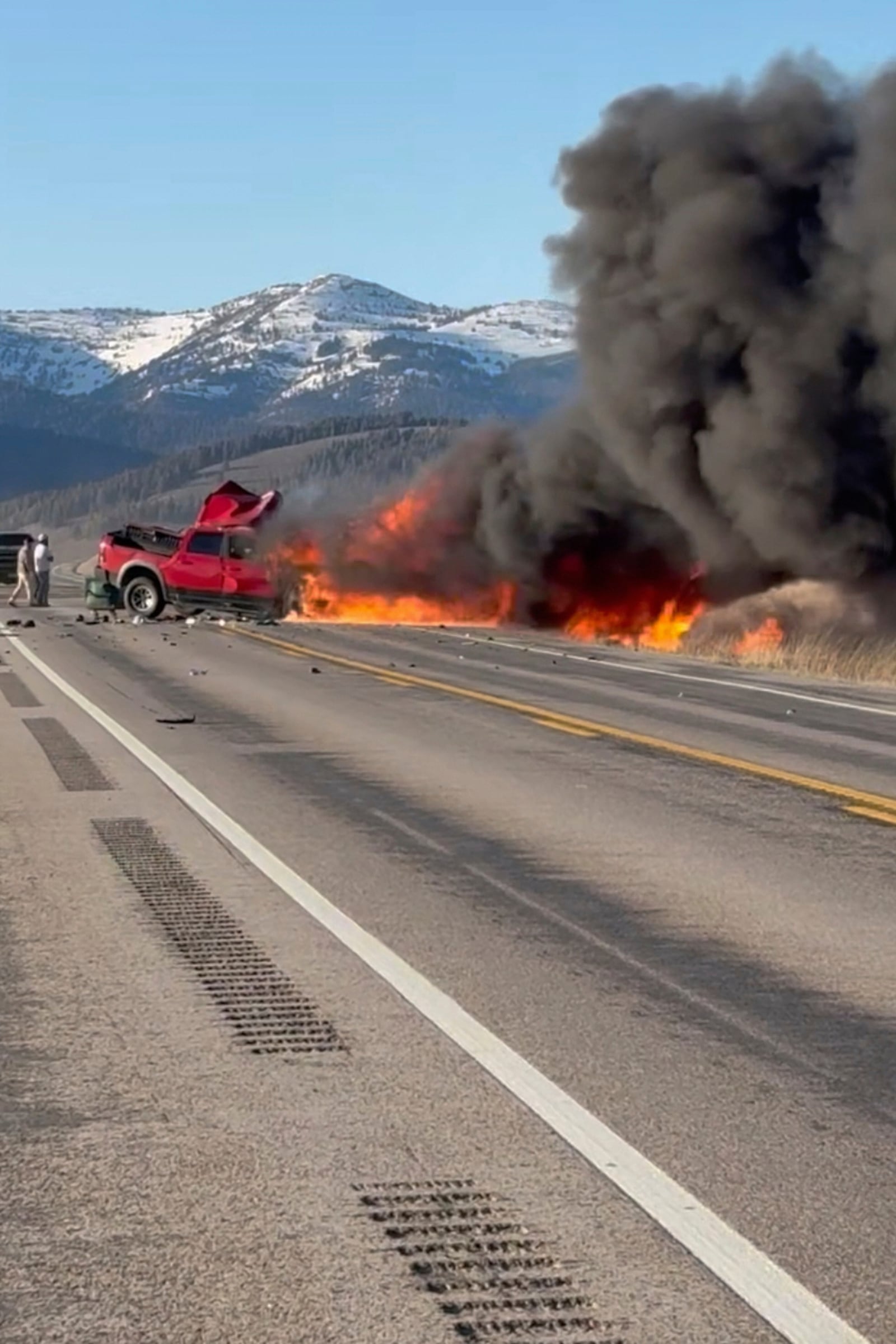 Rescue workers arrive to the scene after a deadly collision between a pickup truck and tour van near Henry’s Lake State Park in eastern Idaho on Thursday, May 1, 2025. (Roger Merrill via AP)