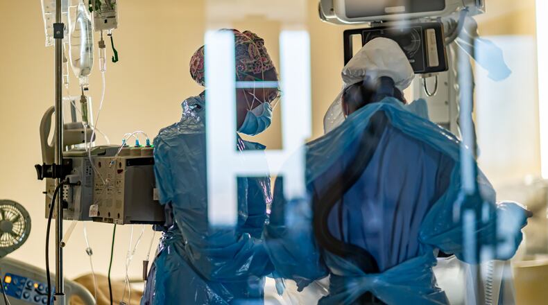 Miami Valley Hospital medical staff work in full PPE gear in a COVID-19 patient room in December. Submitted photo.