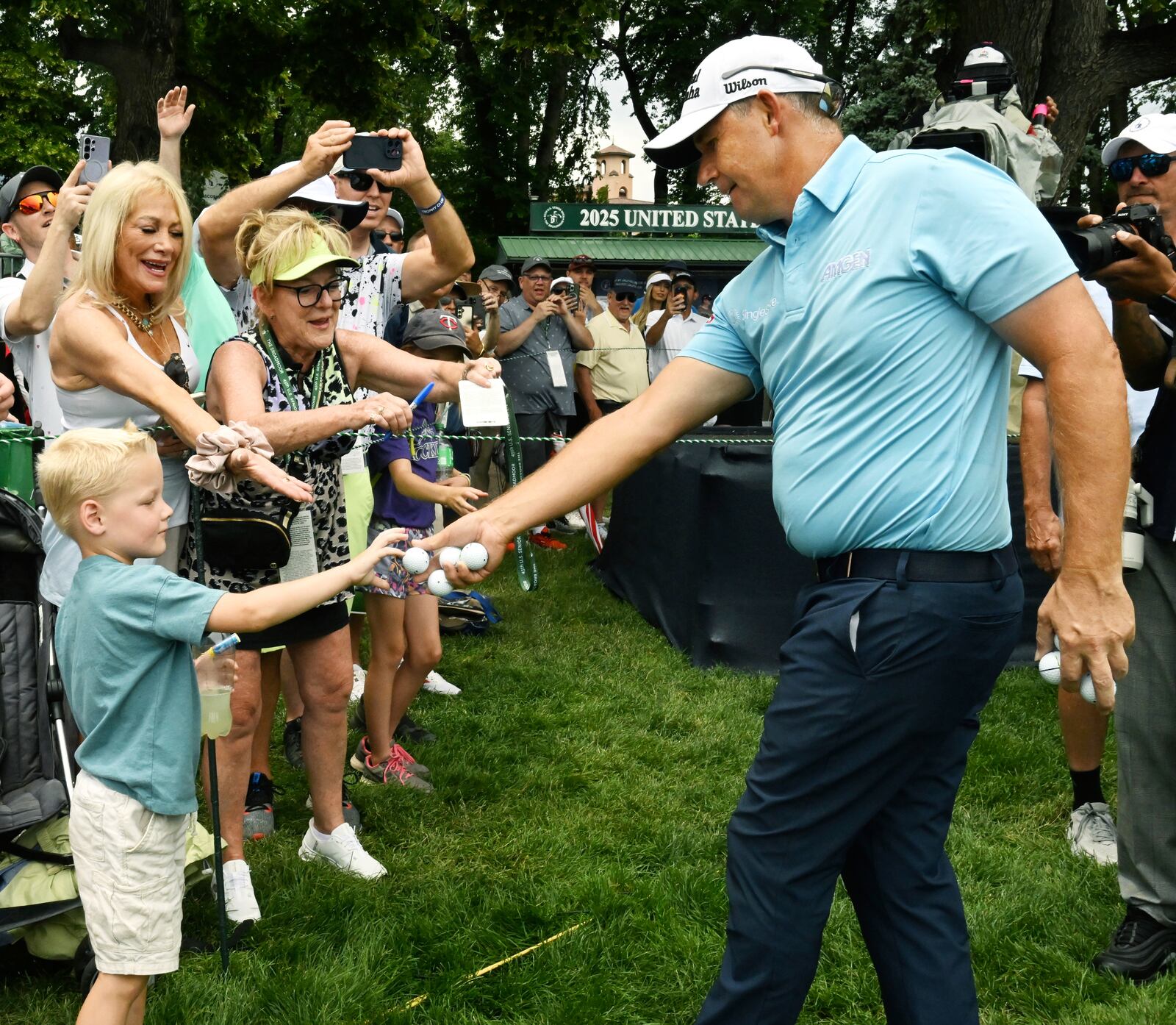 Padragh Harrington, right, hands a ball to Jackson Annen after winning the U.S. Senior Open golf championship at the Broadmoor Golf Club, Sunday, June 29, 2025, in Colorado Springs, Colo. (Jerilee Bennet/The Gazette via AP)